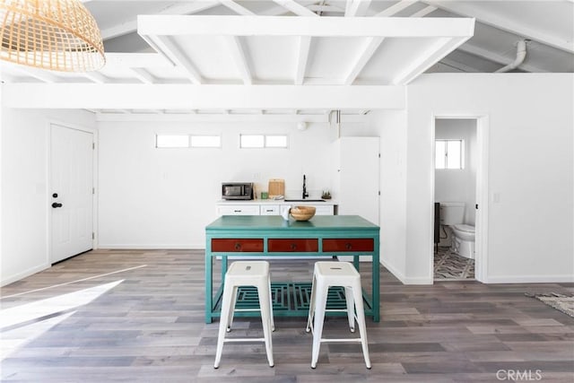 kitchen featuring a healthy amount of sunlight, sink, and hardwood / wood-style floors