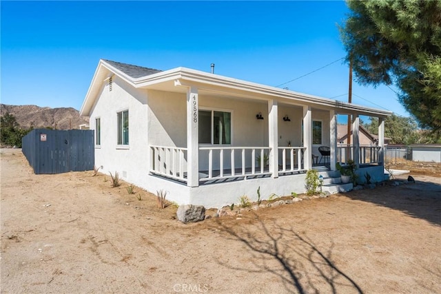 rear view of property with covered porch