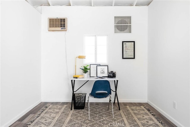 home office featuring wood-type flooring and a wall unit AC