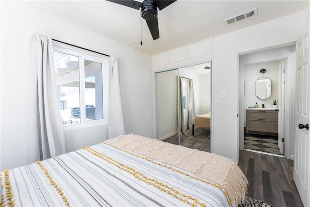 bedroom with dark wood-type flooring, a closet, and ceiling fan