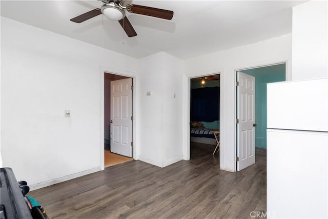 empty room with baseboards and dark wood-style flooring