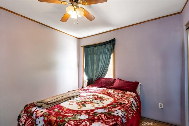 bedroom with ornamental molding and a ceiling fan