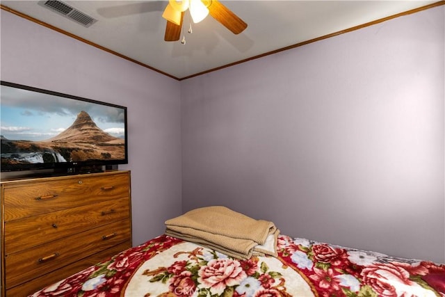 bedroom with ornamental molding, visible vents, and a ceiling fan