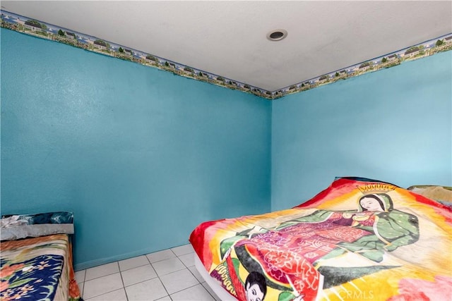 bedroom with light tile patterned floors