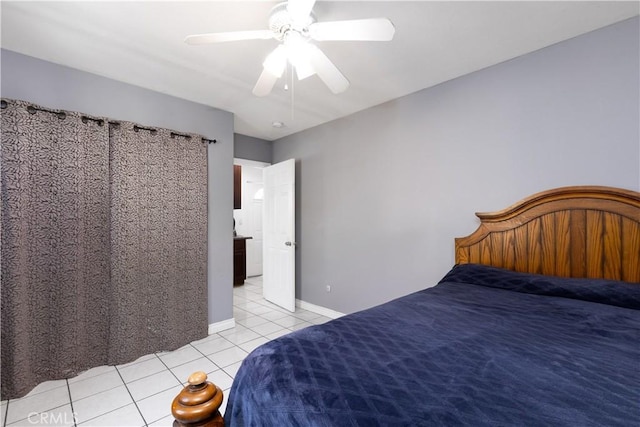 unfurnished bedroom featuring light tile patterned floors, ceiling fan, and baseboards