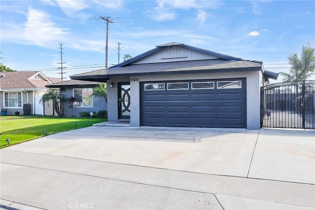 ranch-style home featuring a garage and a front lawn