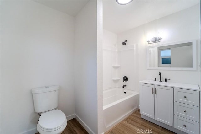 full bathroom with hardwood / wood-style flooring,  shower combination, vanity, and toilet