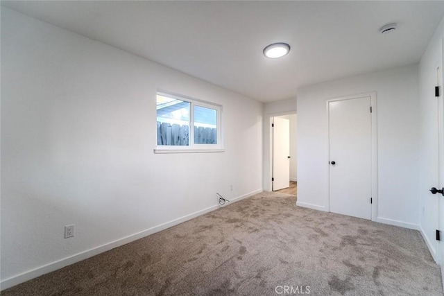 unfurnished bedroom featuring light carpet