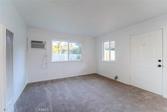 empty room featuring carpet flooring and a wall unit AC