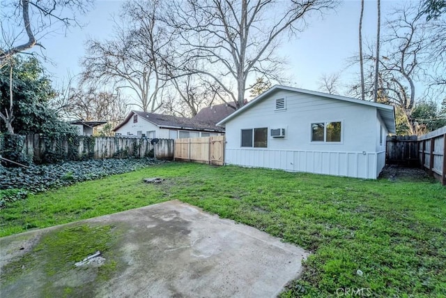 back of house with a lawn and a patio area