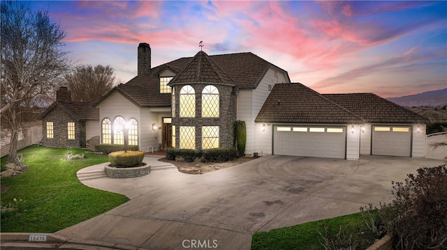 view of front of home featuring a garage and a lawn