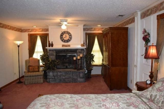 carpeted living room featuring crown molding, a textured ceiling, and a fireplace