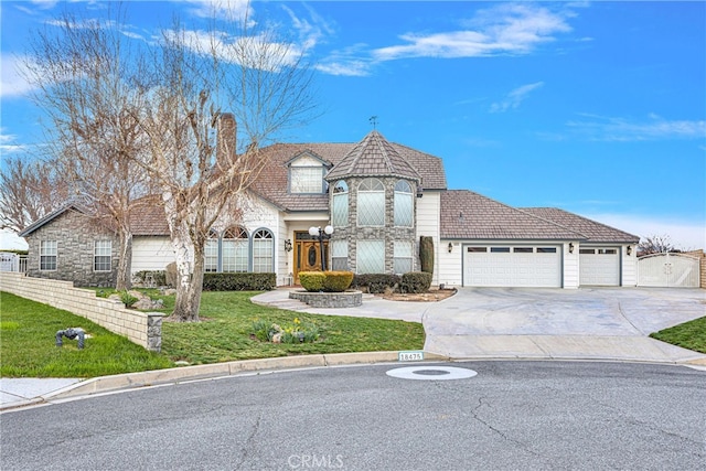 view of front of house featuring a garage and a front yard