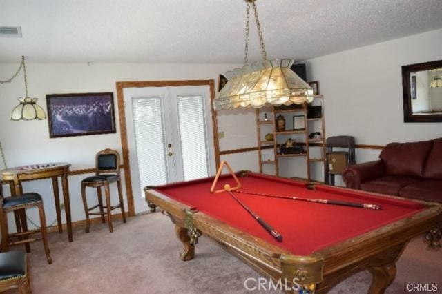 game room featuring french doors, billiards, carpet, and a textured ceiling