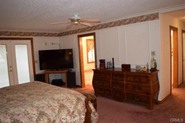 bedroom with crown molding, light colored carpet, ceiling fan, and a textured ceiling