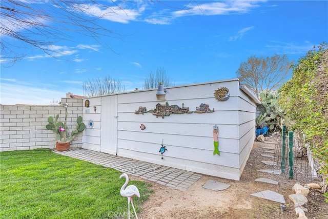 view of outdoor structure featuring a lawn