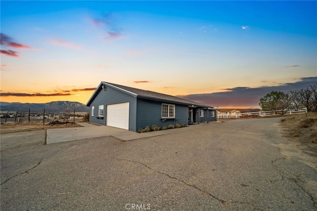 ranch-style house featuring a garage and a mountain view