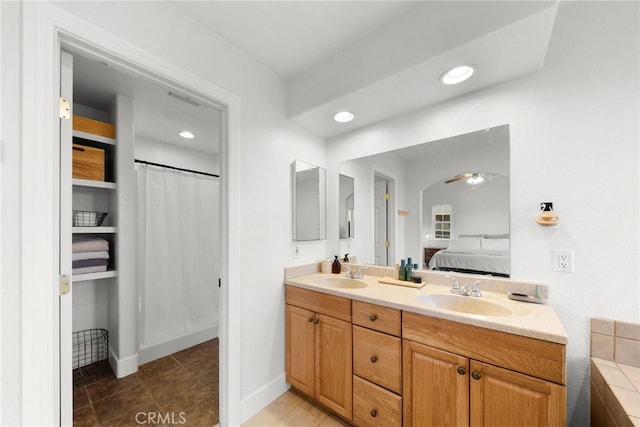 bathroom with tile patterned flooring, vanity, and ceiling fan