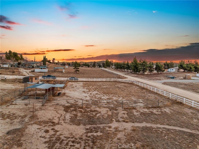 yard at dusk with a rural view