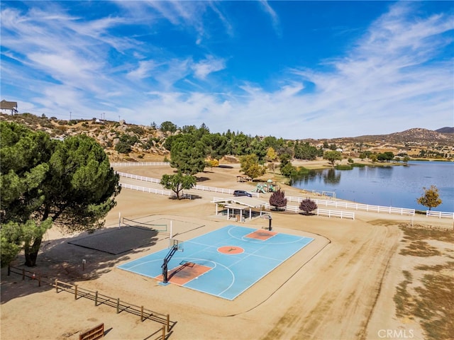 view of sport court with a water and mountain view