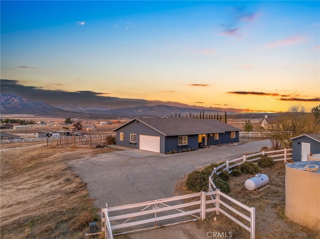 view of front of house with a garage and a mountain view