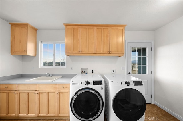 washroom featuring sink, cabinets, and washing machine and clothes dryer