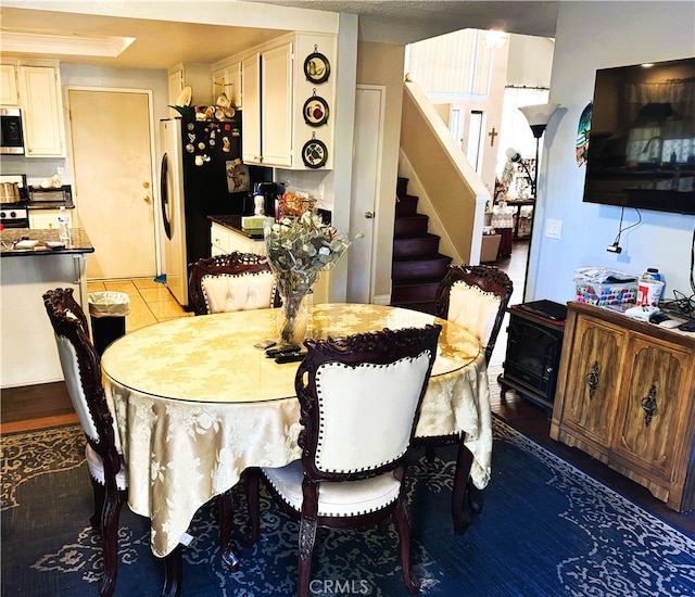 tiled dining space with a tray ceiling