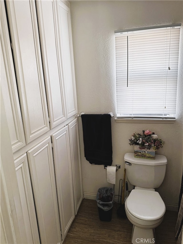 bathroom with hardwood / wood-style floors and toilet