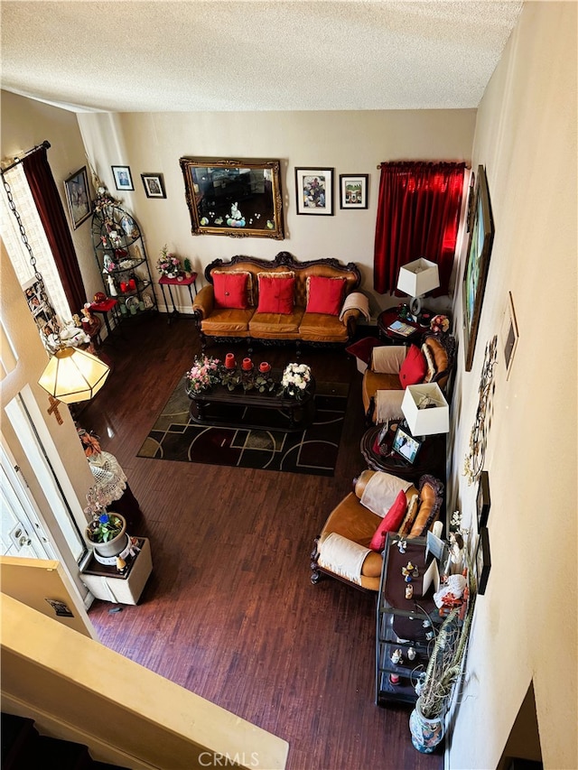 living room featuring hardwood / wood-style flooring and a textured ceiling