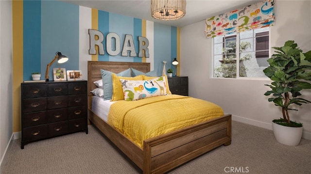 bedroom with carpet and a notable chandelier