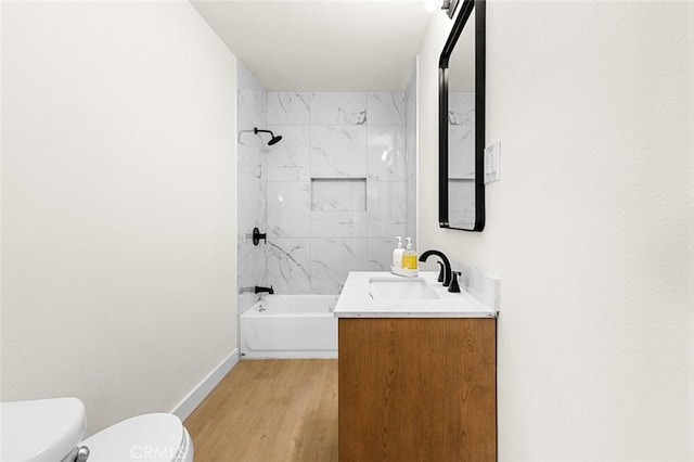 full bathroom featuring shower / tub combination, toilet, wood finished floors, vanity, and baseboards