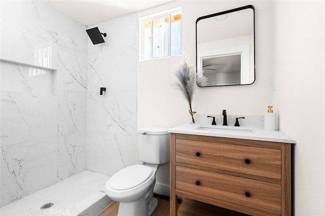 full bathroom with toilet, a marble finish shower, and vanity