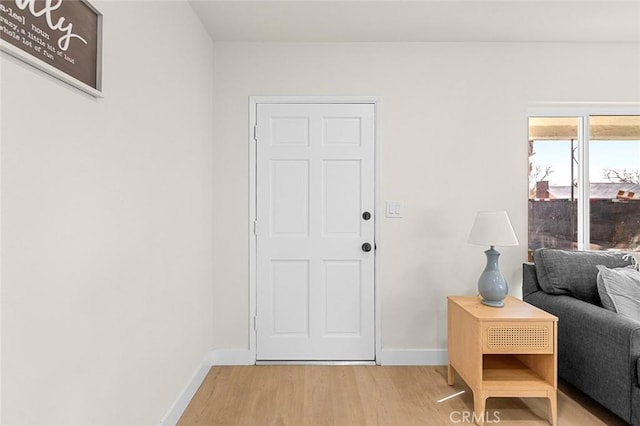 interior space featuring light wood finished floors and baseboards