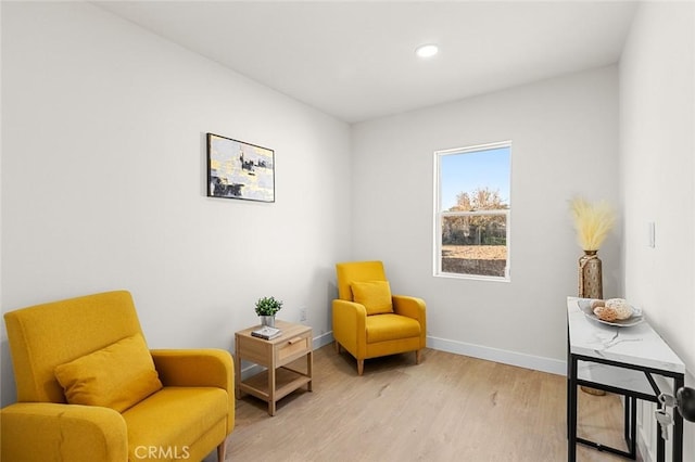 living area with recessed lighting, baseboards, and light wood finished floors