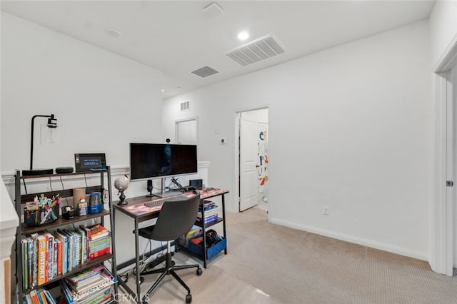 home office with baseboards, visible vents, and light colored carpet