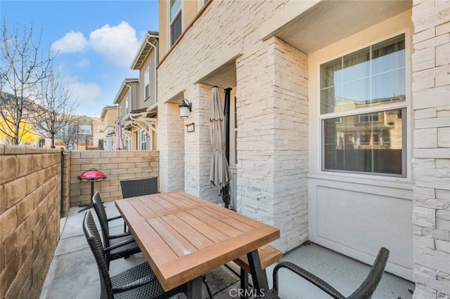 view of patio with outdoor dining space and fence