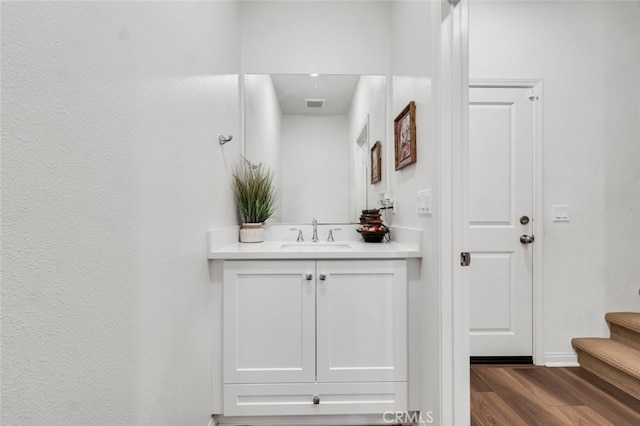 bathroom featuring vanity, wood finished floors, and visible vents