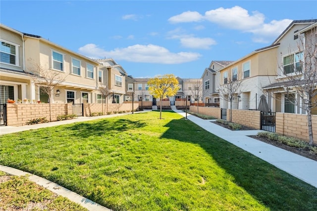 view of yard featuring fence and a residential view