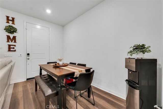 dining room featuring dark wood-type flooring and baseboards