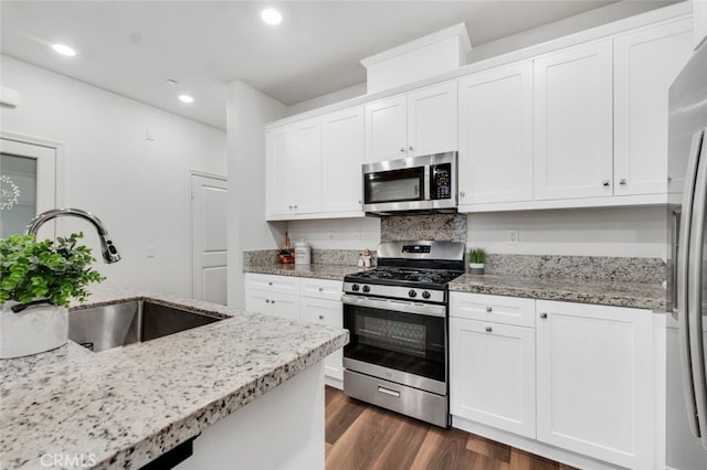 kitchen with sink, stainless steel appliances, and white cabinets