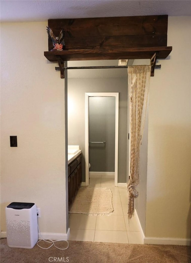 bathroom with tile patterned flooring and vanity