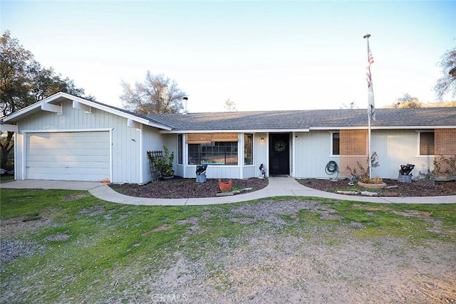 ranch-style home featuring a garage and a front yard