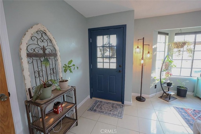 entryway featuring light tile patterned floors and a healthy amount of sunlight