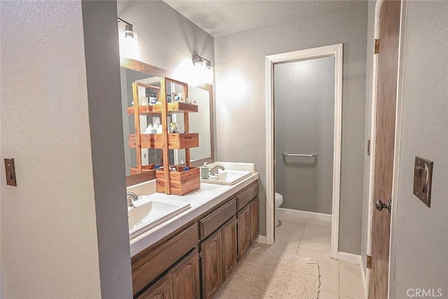 bathroom featuring vanity, toilet, and tile patterned flooring