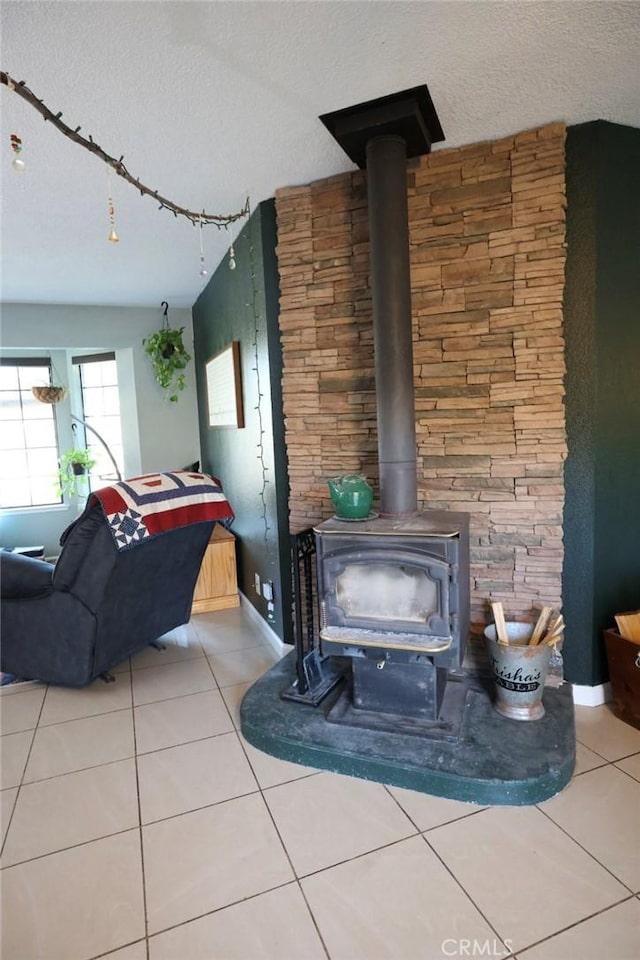 interior details with a textured ceiling and a wood stove