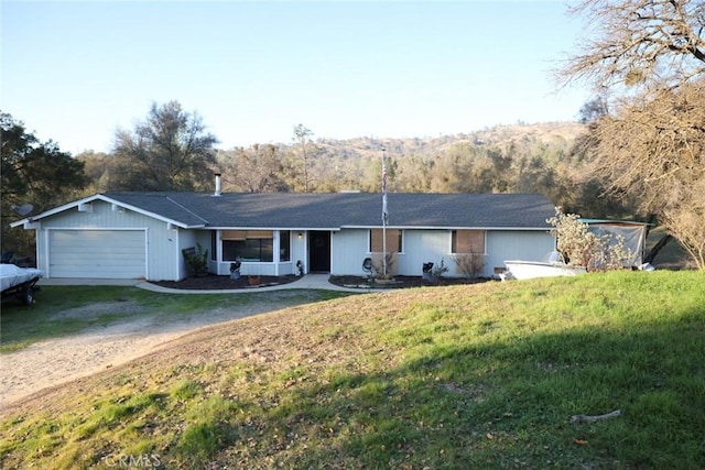 ranch-style house featuring a garage, a front lawn, and a porch