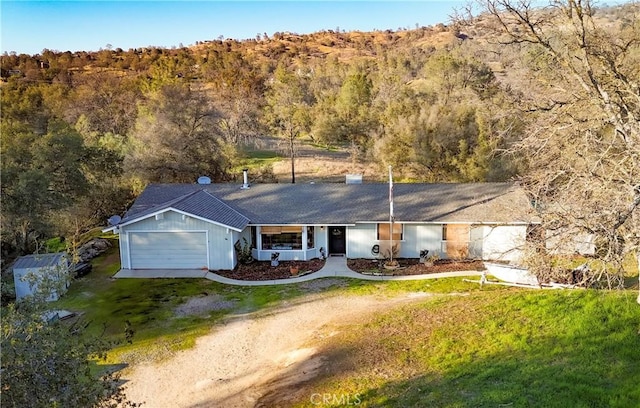 ranch-style home featuring a garage and a front lawn