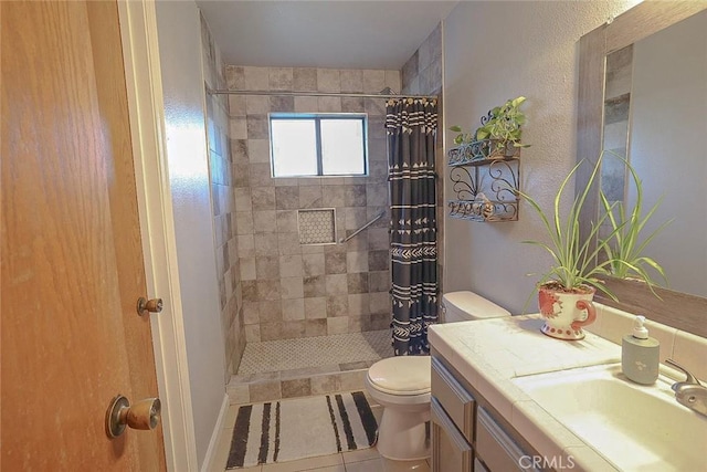 bathroom featuring vanity, tile patterned flooring, toilet, and walk in shower