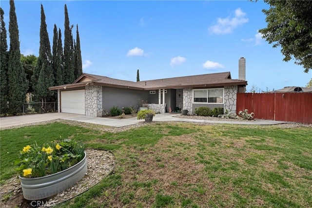 ranch-style home featuring a garage and a front lawn