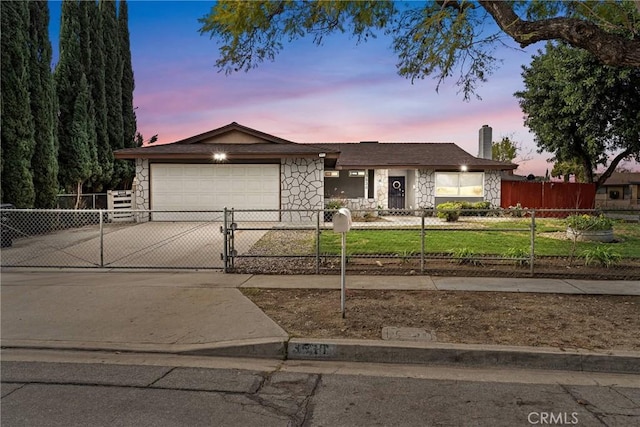 view of front facade with a yard and a garage